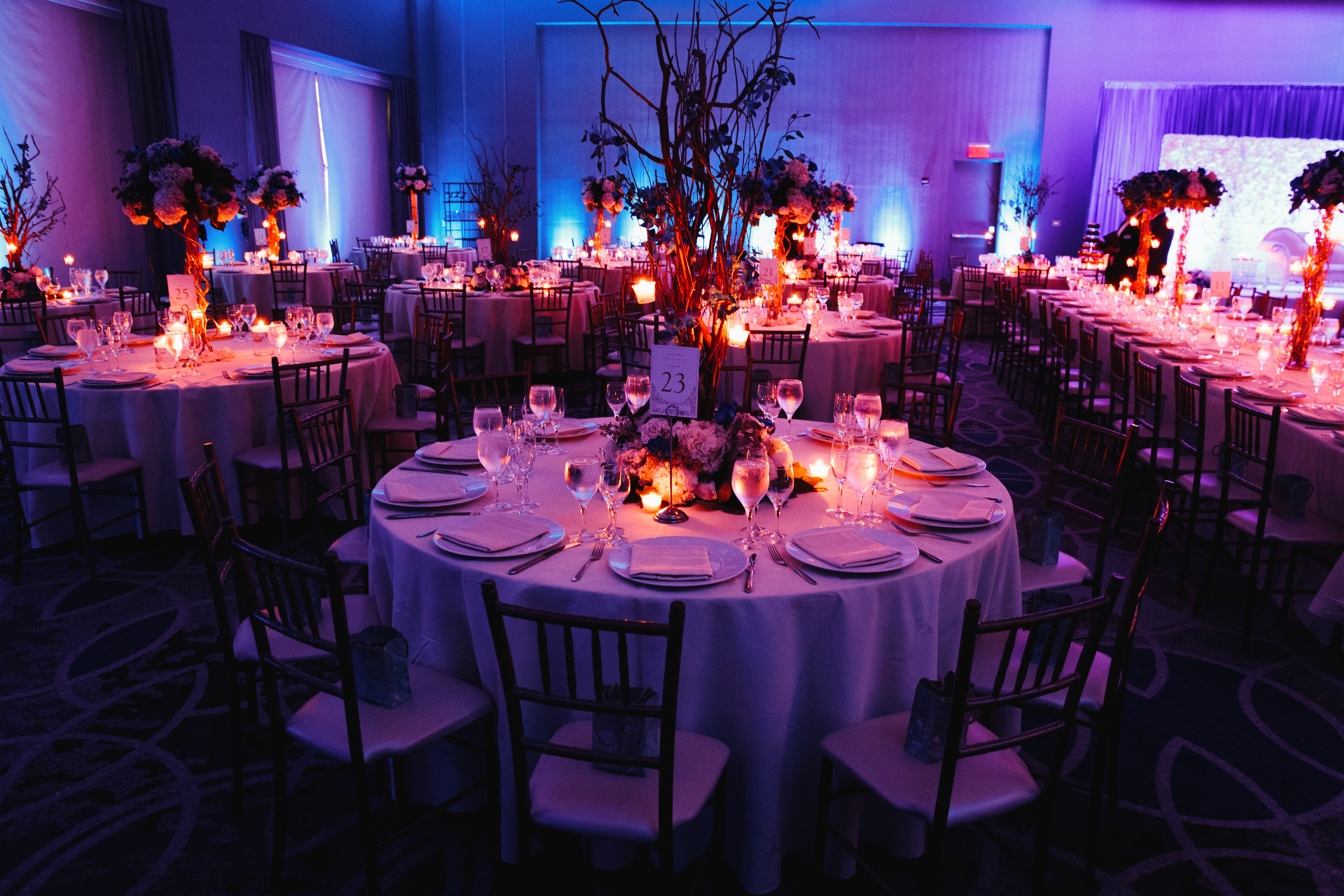 decorated-wedding-hall-with-candles-round-tables-centerpieces.jpg
